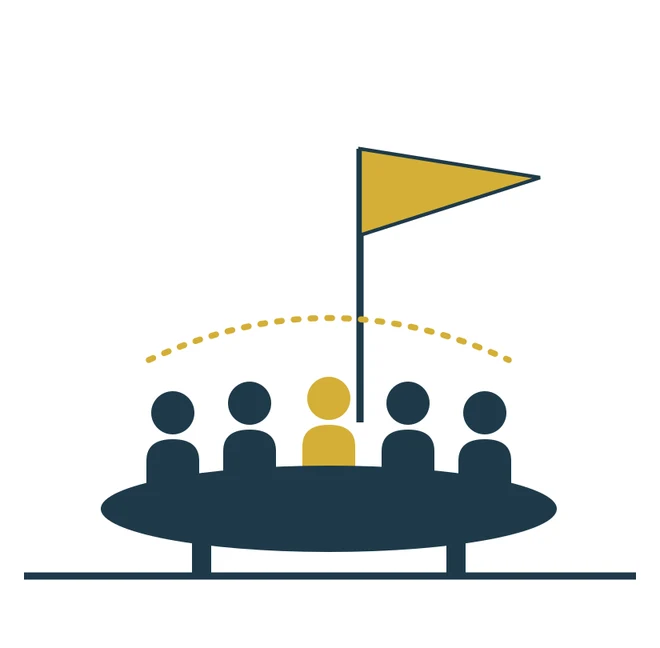 A team around a table beneath a flag marked Mission.